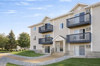 Three story apartment building with balconies and entrance